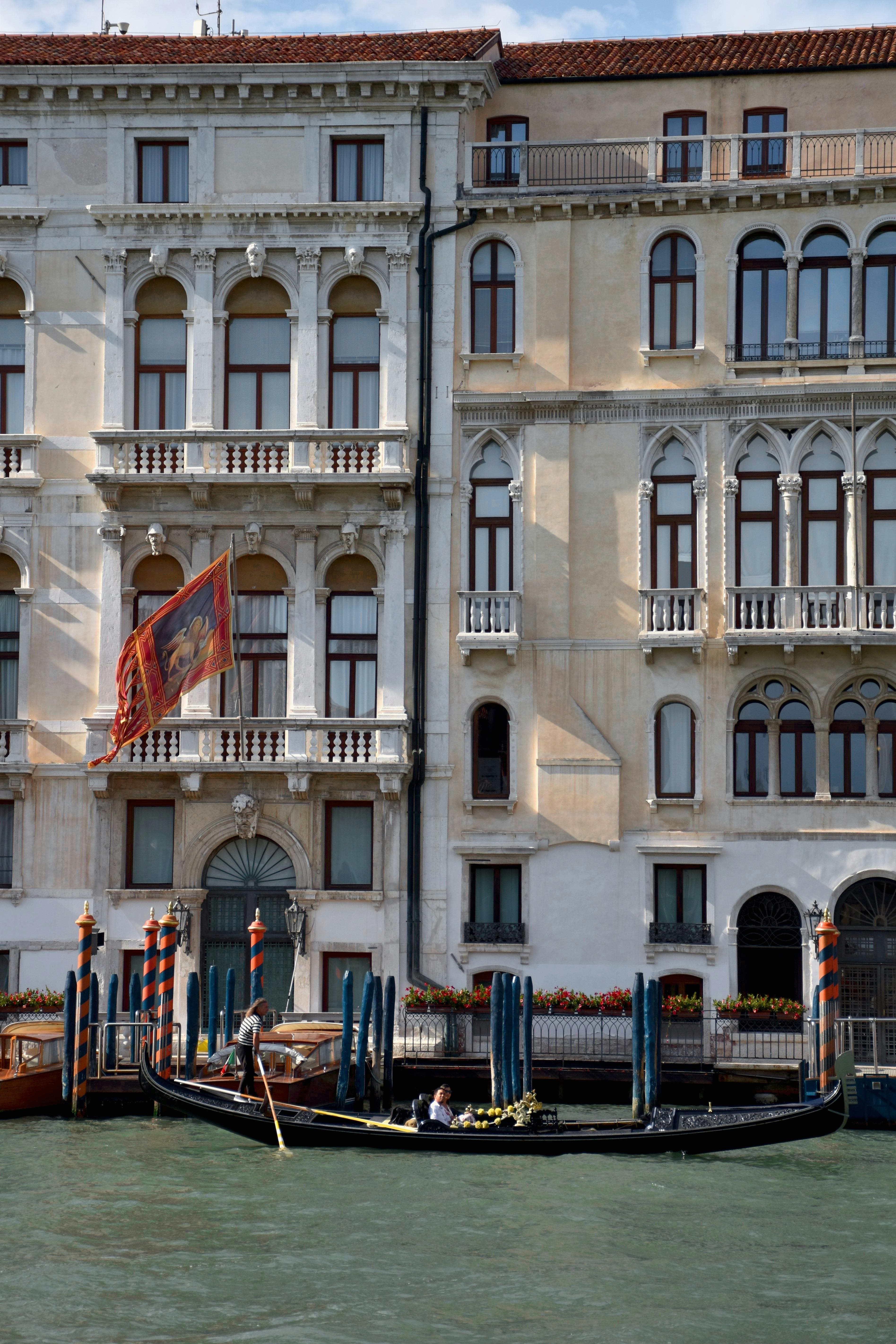 Explore the iconic canals of Venice with traditional gondolas against historic architecture.