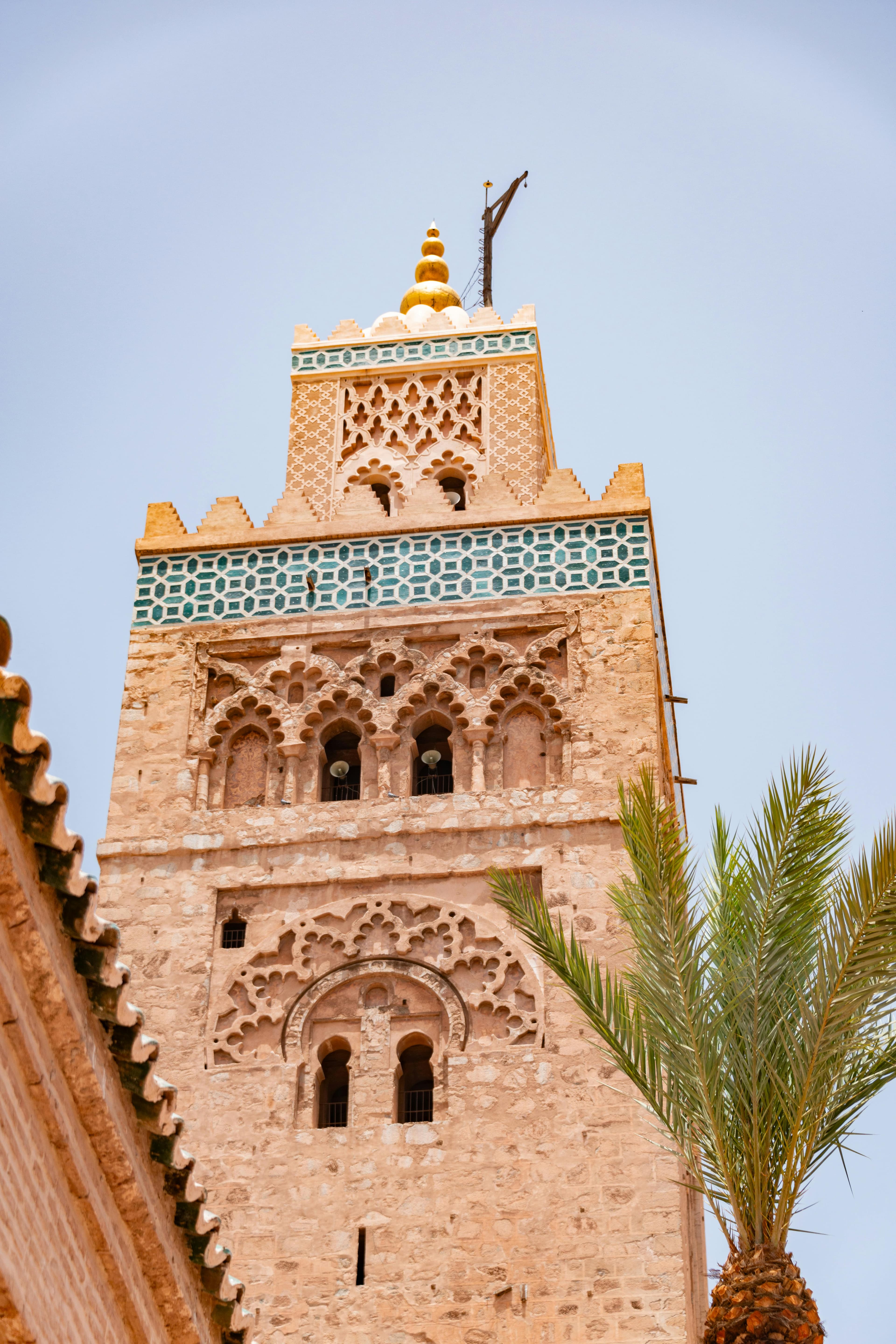 Capture of the Kutubiyya Mosque minaret with palm silhouette in Marrakech, Morocco.