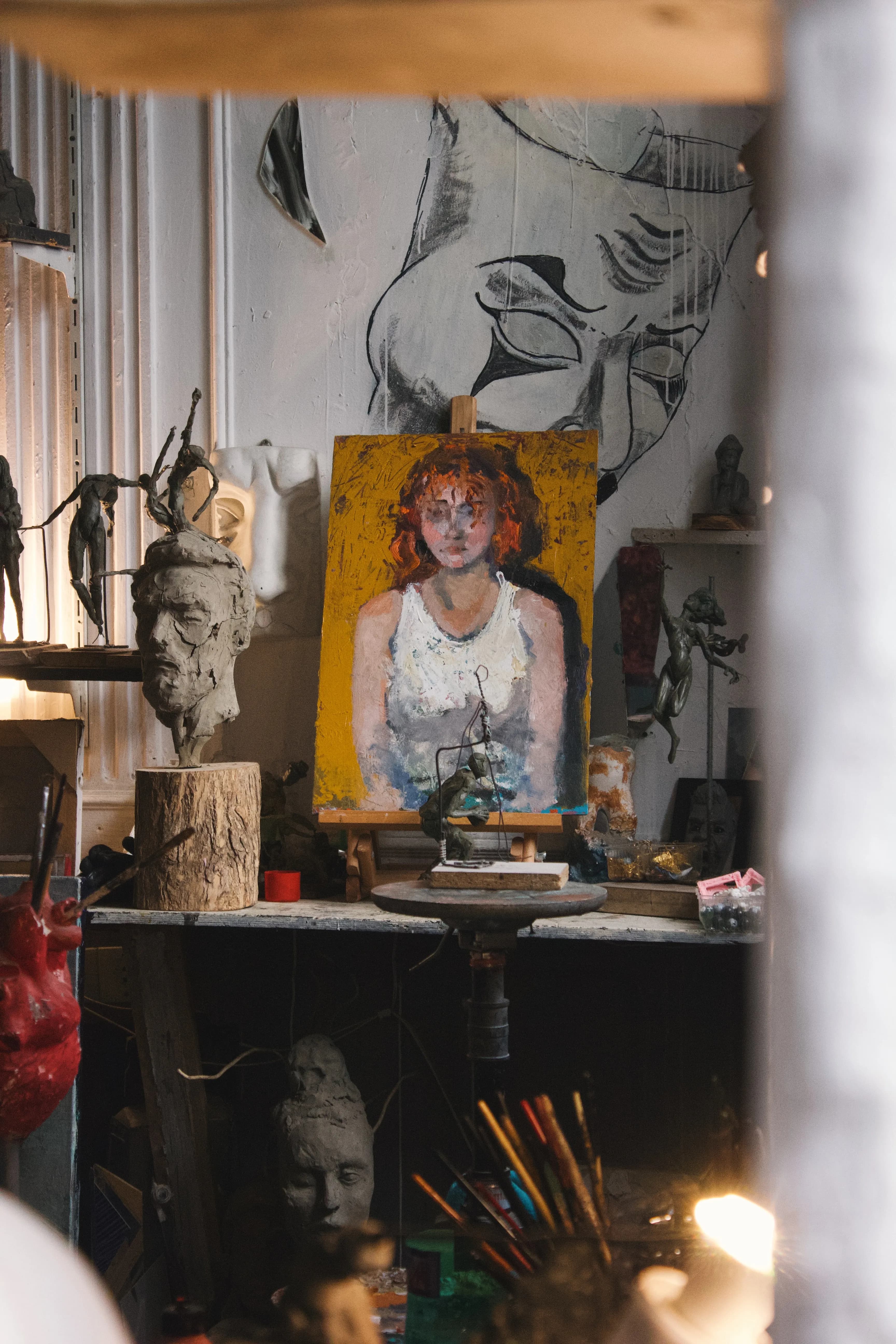 Colorful painting and sculptures in an artist's studio, showcasing creativity and craft.