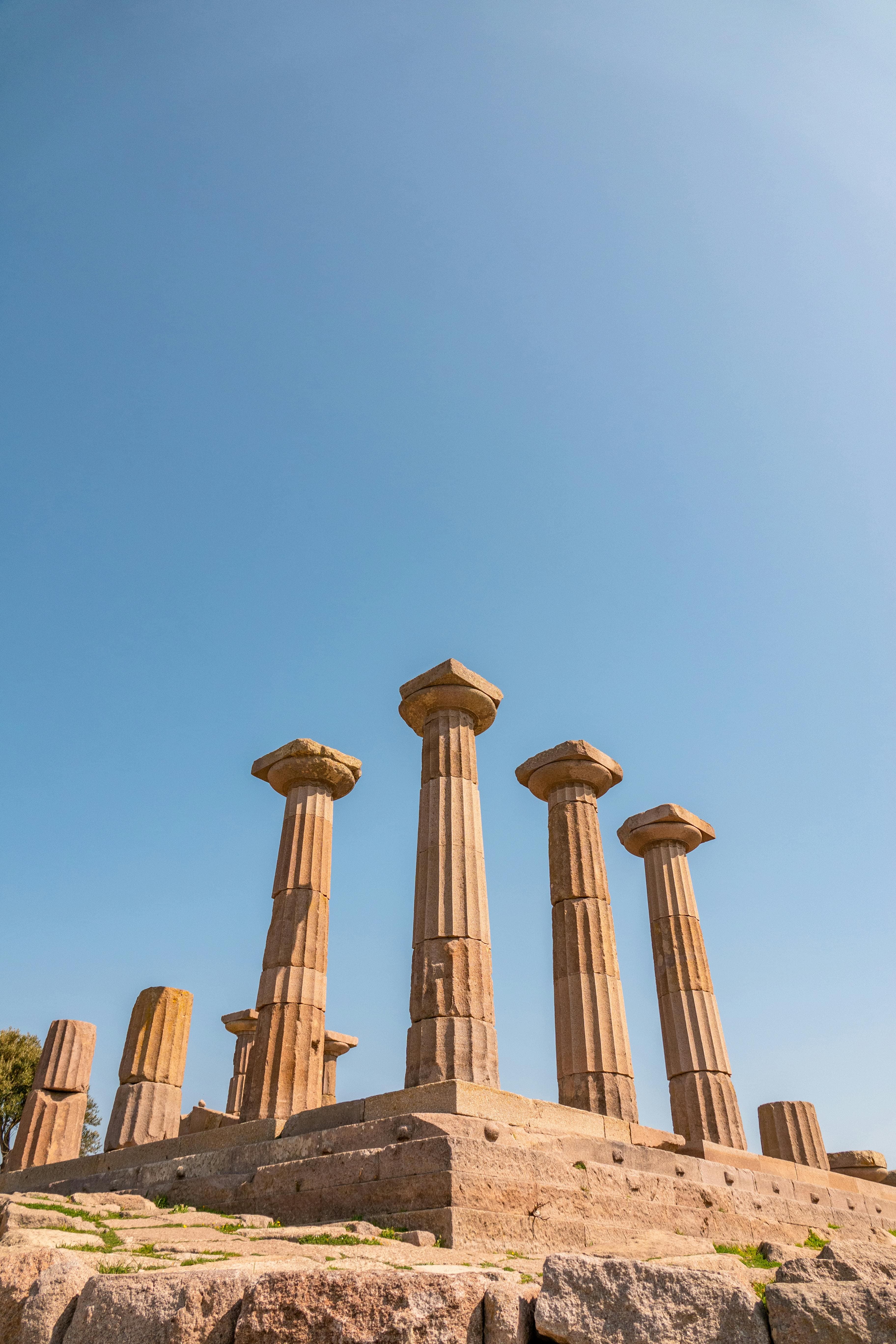 Explore the majestic ancient Greek temple ruins in Behram, Çanakkale under a clear blue sky.