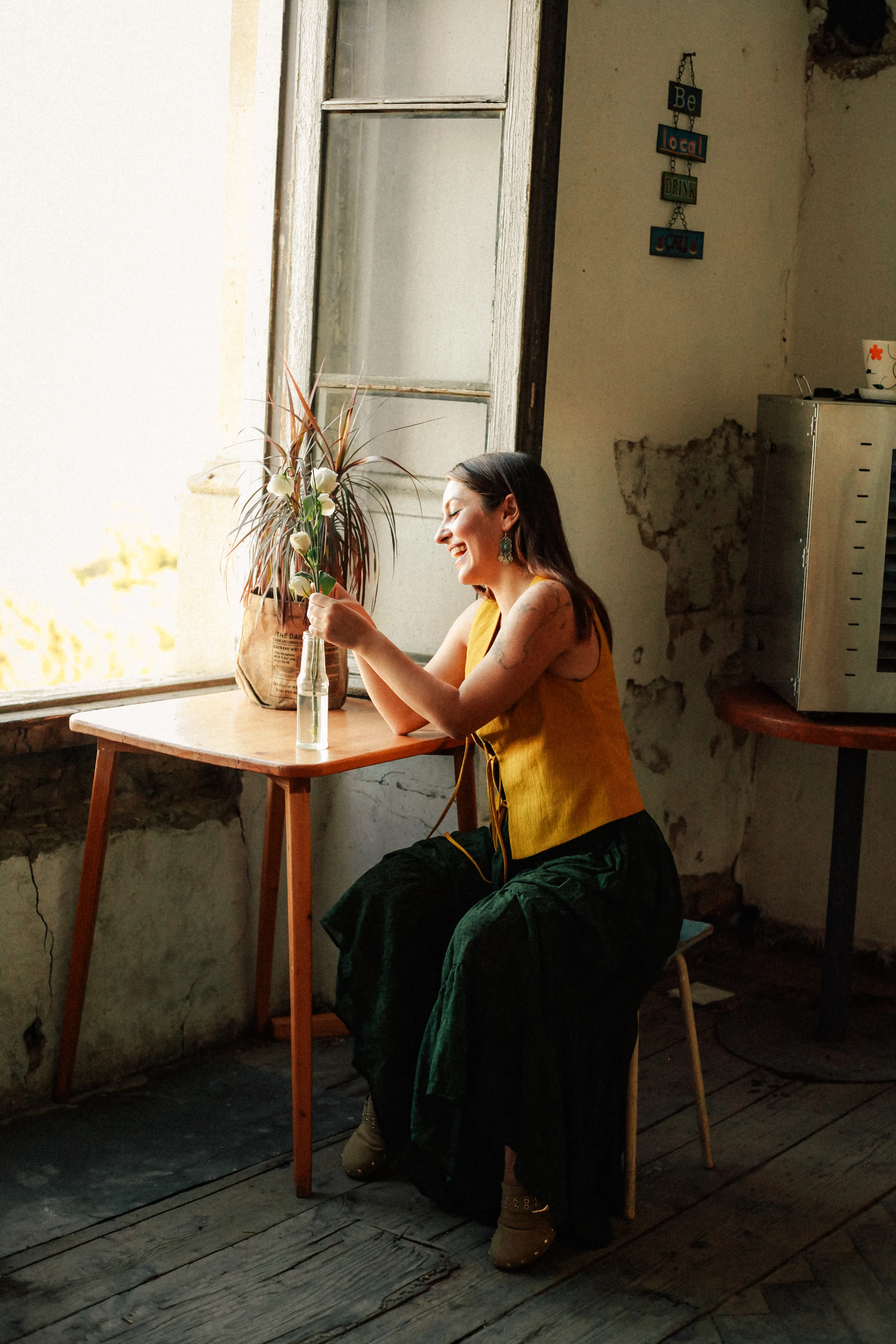 Relaxed bohemian woman in a cozy Baku cafe, embracing a summer vibe.