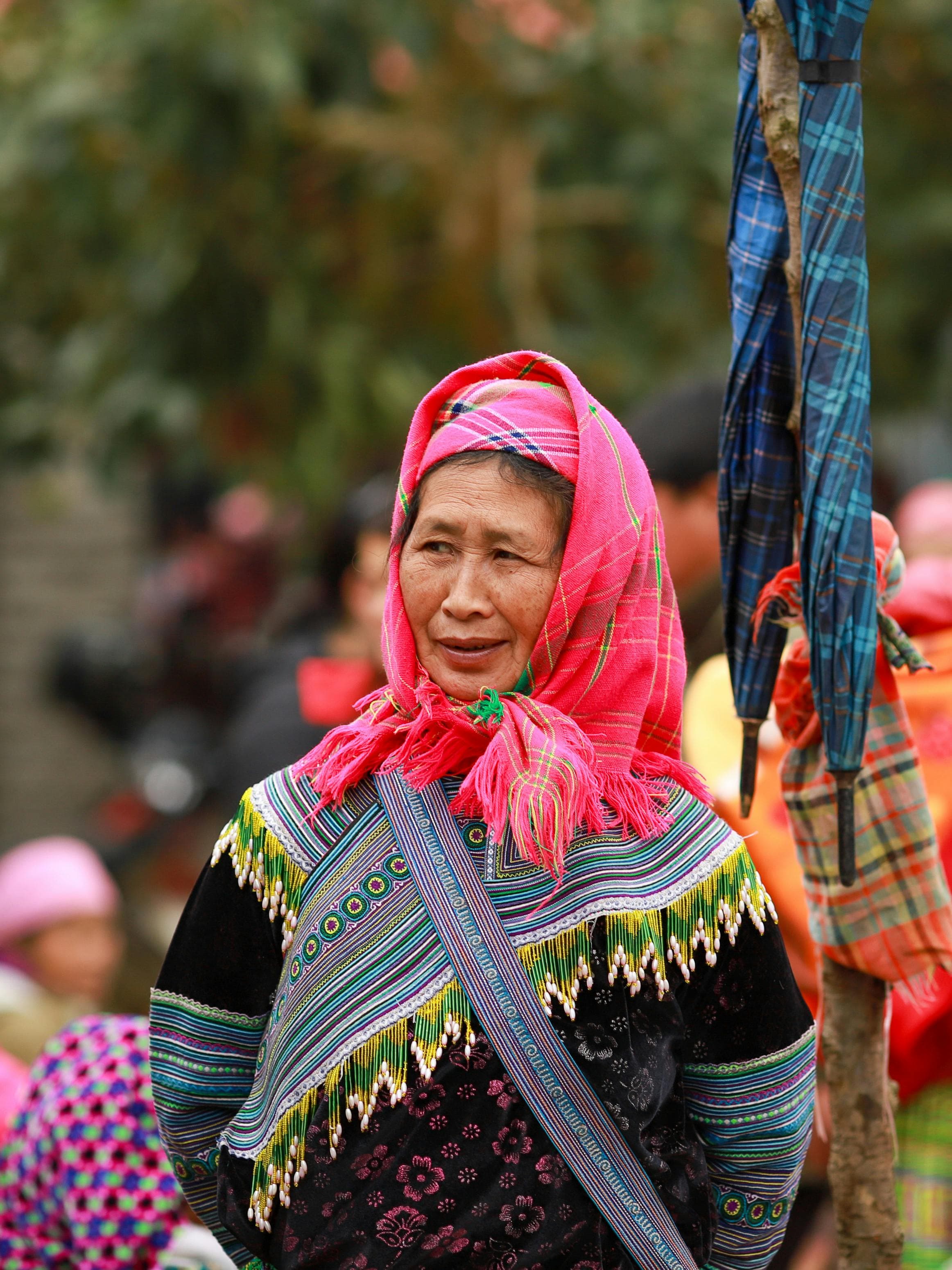 Portrait of a Hmong woman showcasing traditional attire in Lào Cai, Vietnam.