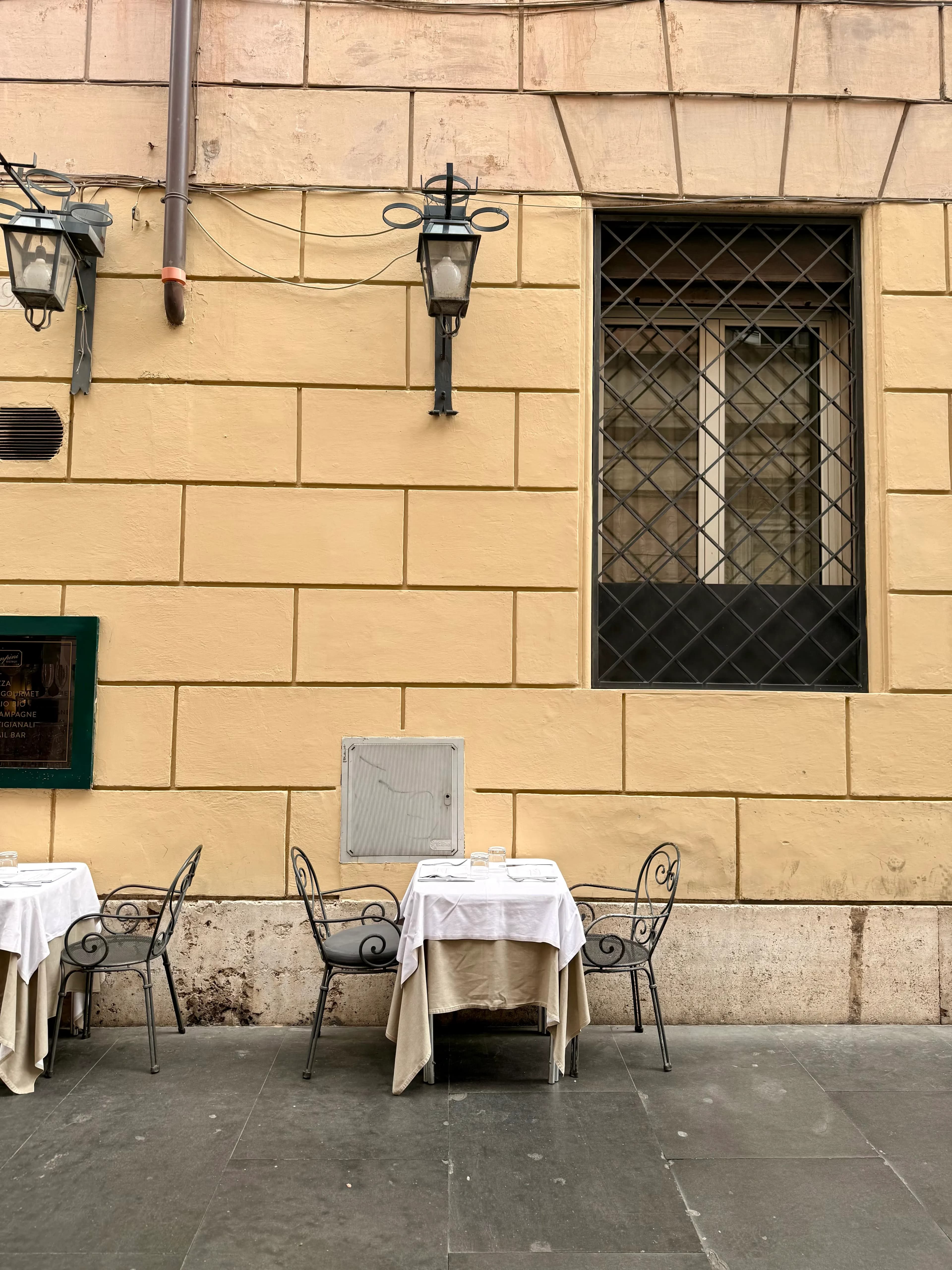 Cozy outdoor cafe scene in Rome, showcasing Italian architecture and charm.