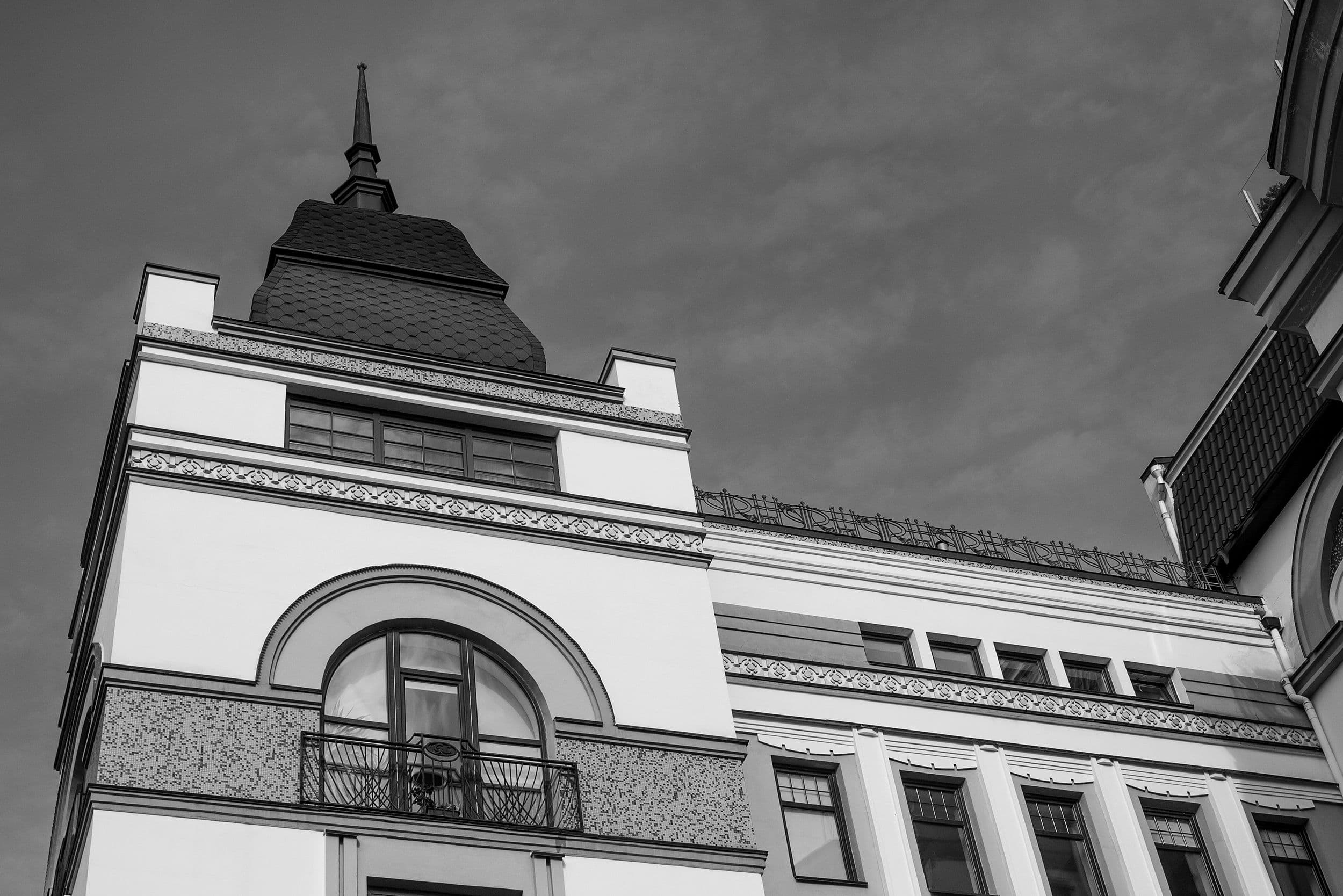 A detailed view of an ornate historic building showcasing intricate architectural details in black and white.