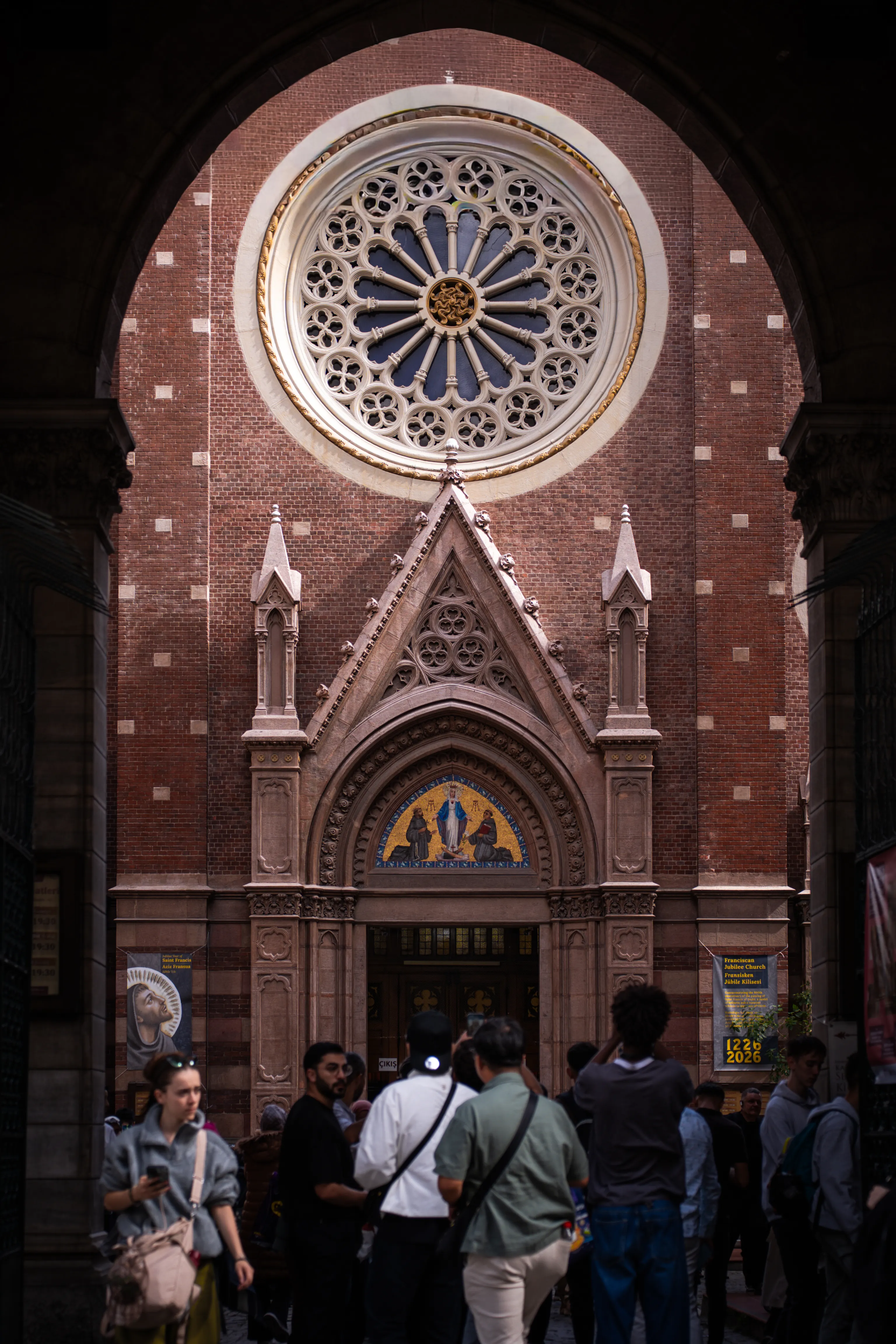 Visitors gather at the entrance of St. Anthony of Padua Church, Istanbul's largest Catholic church, showcasing Gothic Revival architecture.
