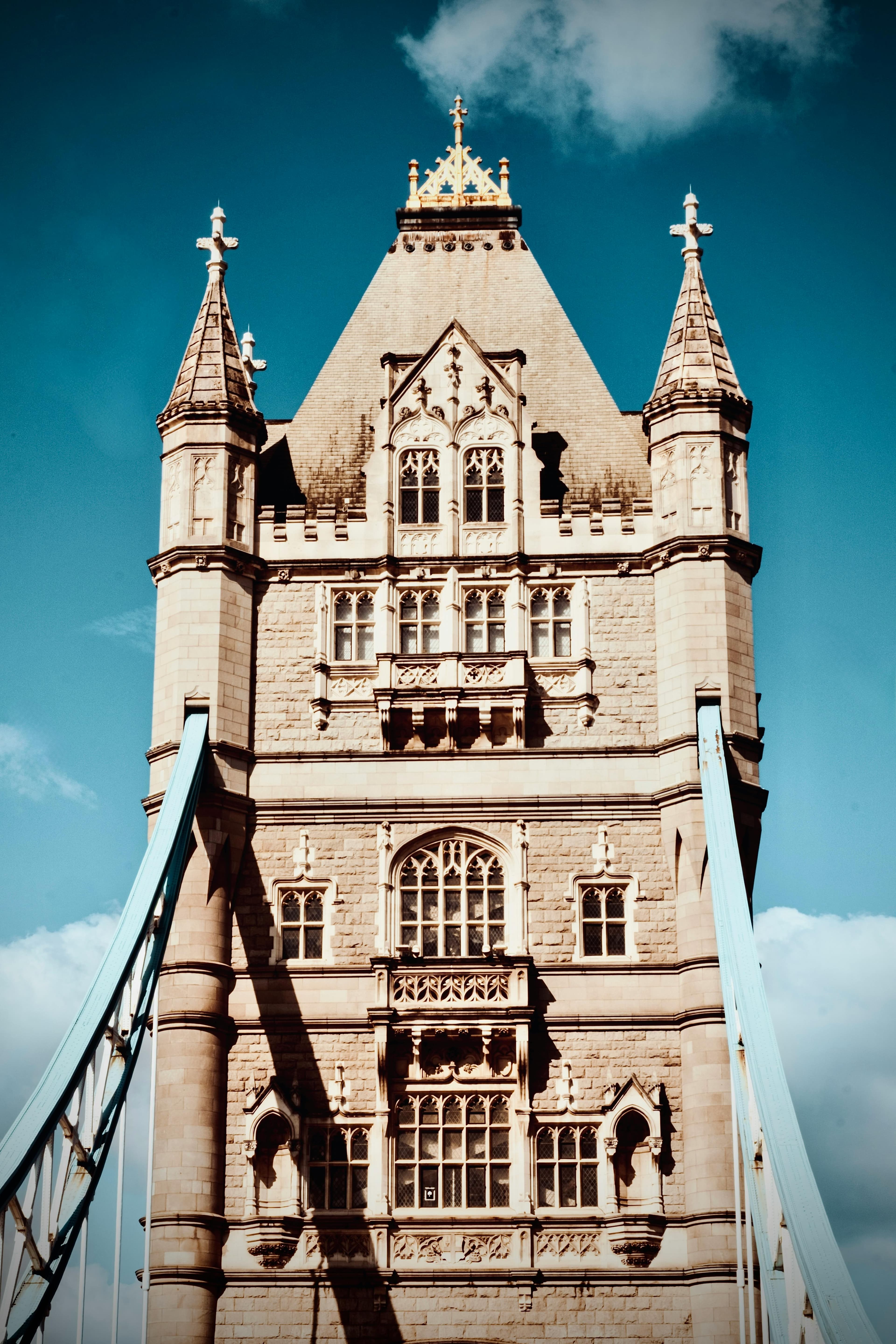 Intricate architectural details of Tower Bridge in London against a blue sky.